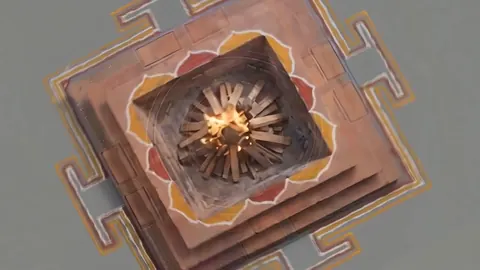 A square yantra seen from above, drawn as a silicon die, with lotus petals and a fire burning at its centre.