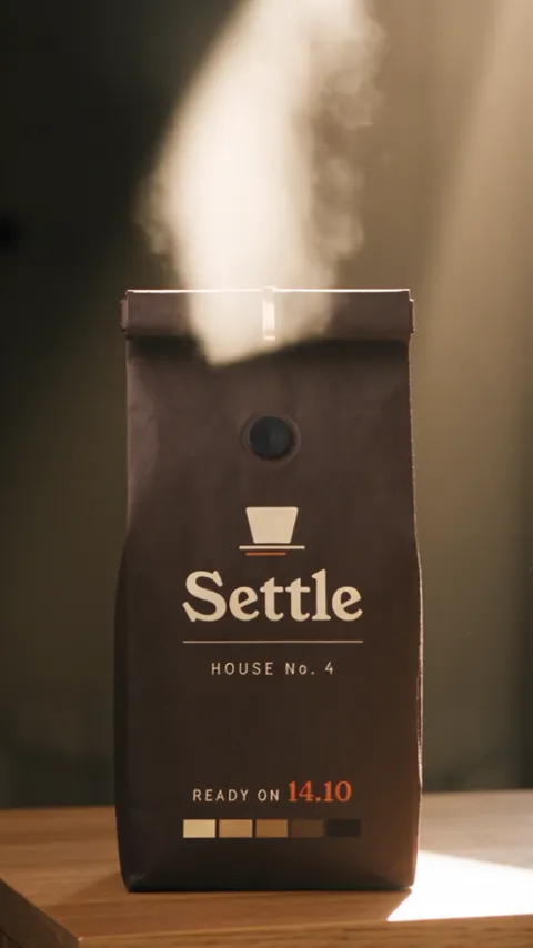 The same bag with a large pale plume of aroma rising above it, the Settle label facing the camera.