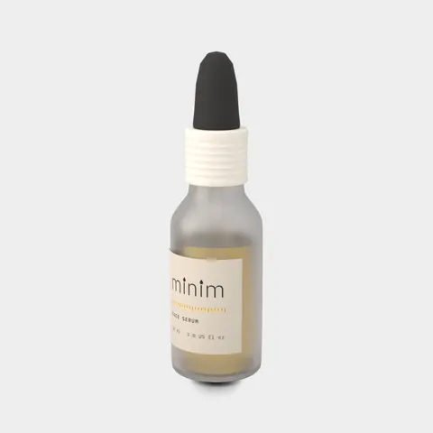 Three-quarter view of the same frosted serum bottle showing the label and the ribbed white collar.