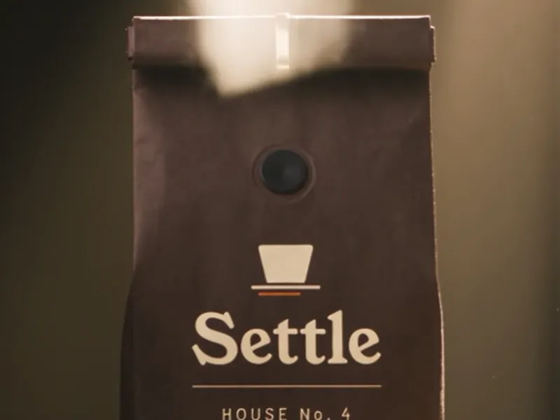 A Settle coffee bag with a breath of steam rising from the top